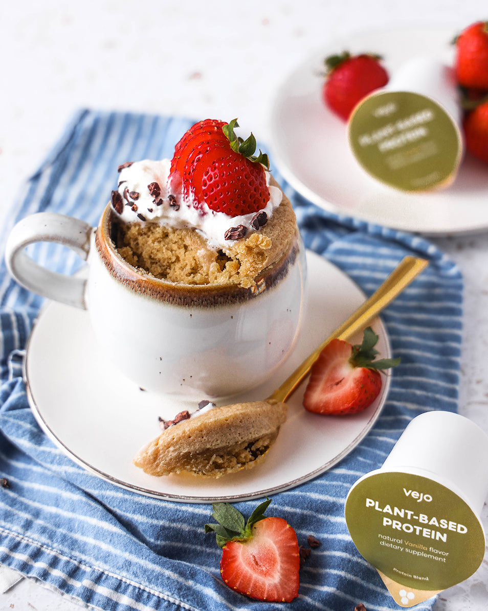 A strawberry vanilla mug cake with vanilla plant-based protein blends.